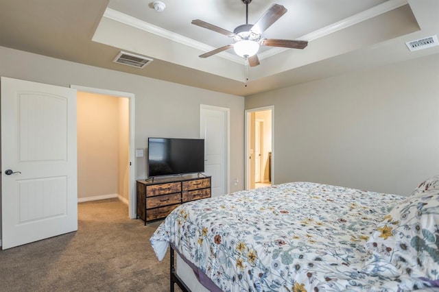 carpeted bedroom with a tray ceiling, ceiling fan, and ornamental molding