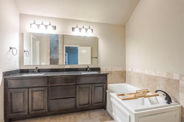 bathroom featuring vanity and a bath