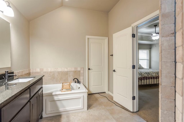 bathroom featuring tile patterned floors, a bathtub, vanity, vaulted ceiling, and ceiling fan