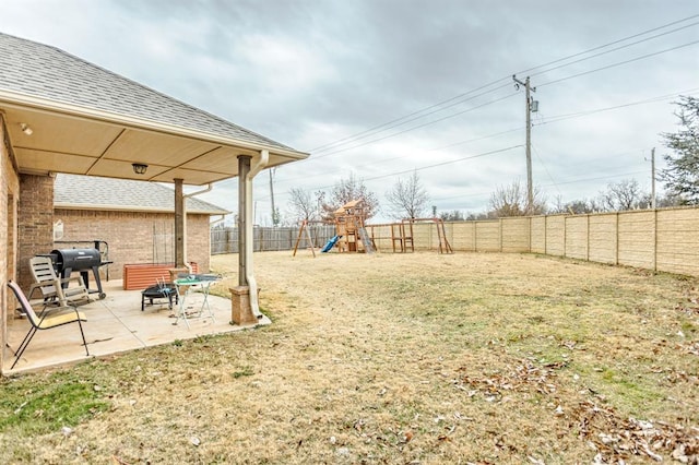 view of yard with a playground and a patio