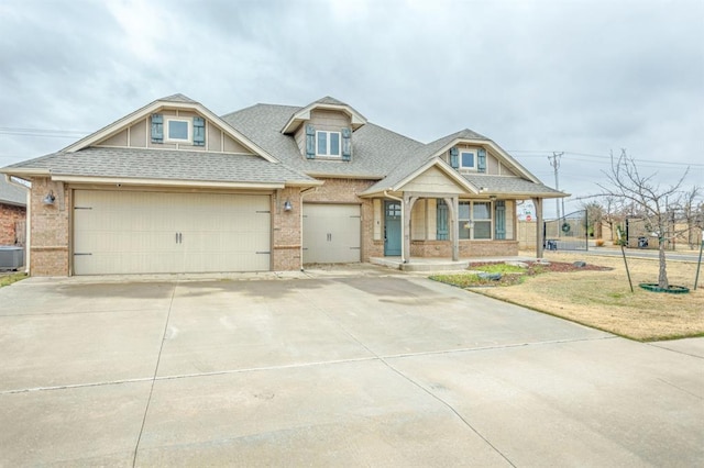 view of front of house featuring covered porch, central AC, a garage, and a front lawn