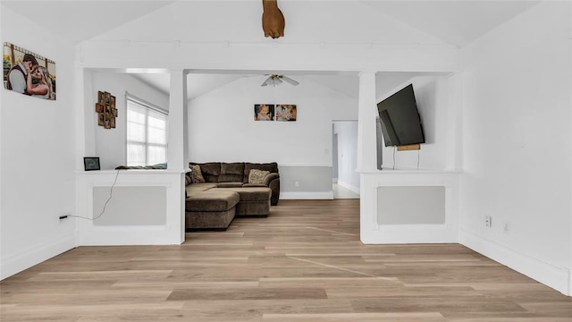 living room featuring hardwood / wood-style flooring, ceiling fan, and lofted ceiling