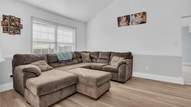 living room with light hardwood / wood-style floors and lofted ceiling