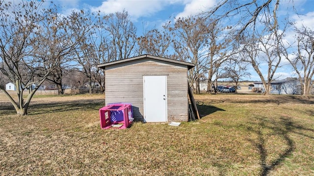 view of outbuilding with a yard