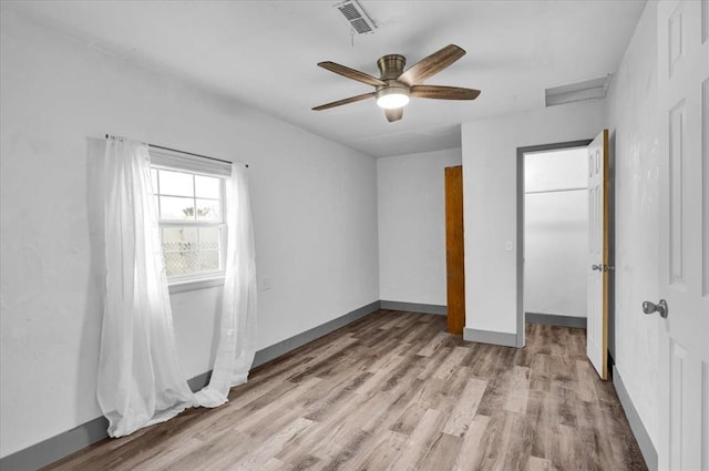 unfurnished bedroom with ceiling fan and light hardwood / wood-style floors