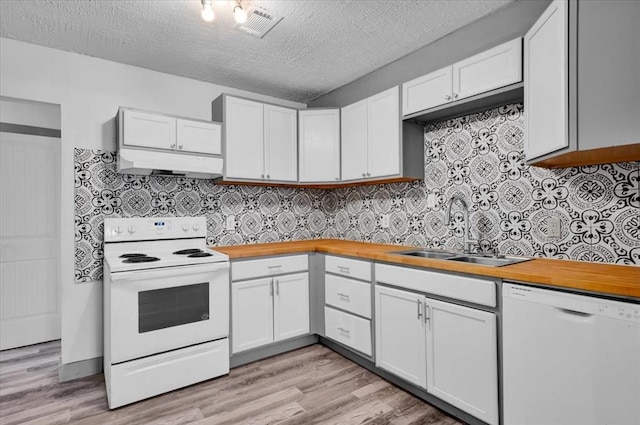 kitchen featuring white cabinets, a textured ceiling, white appliances, and sink