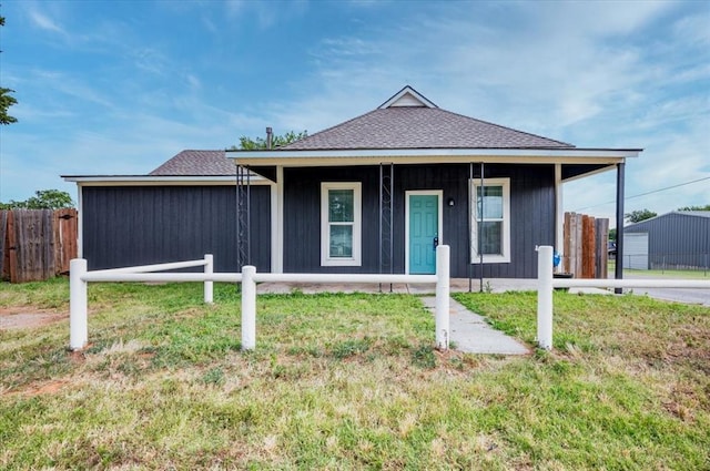 view of front of home with covered porch and a front yard