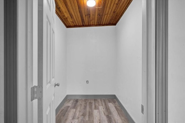 washroom with light wood-type flooring, wood ceiling, and ornamental molding