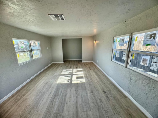 unfurnished room with light hardwood / wood-style flooring