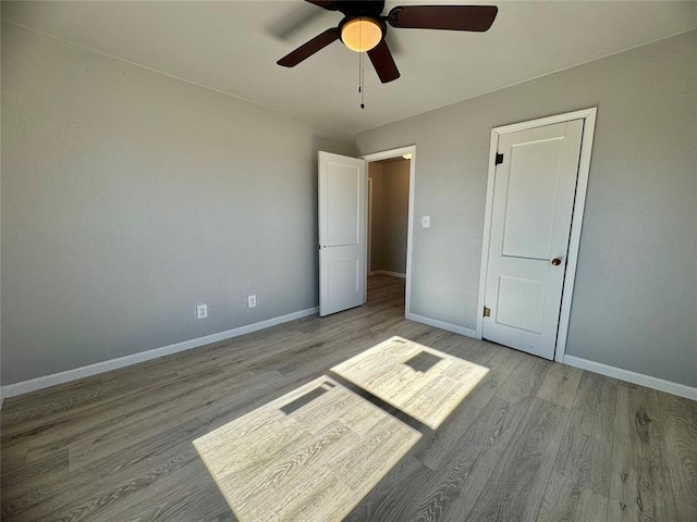 unfurnished bedroom with ceiling fan and light hardwood / wood-style floors