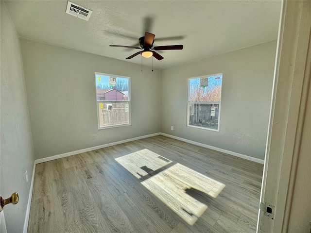 empty room featuring ceiling fan and light hardwood / wood-style flooring