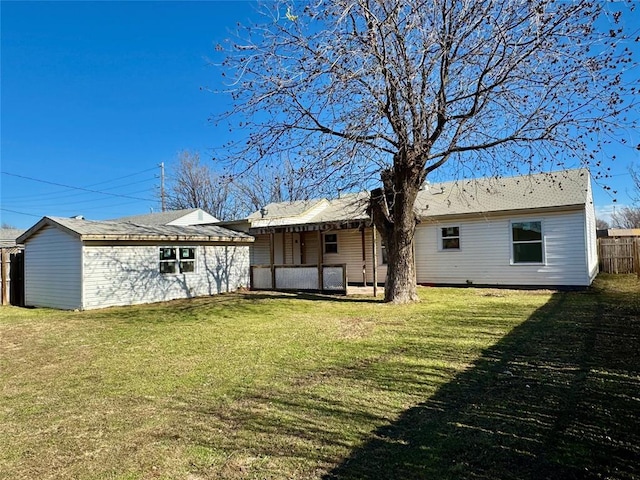 rear view of house featuring a yard