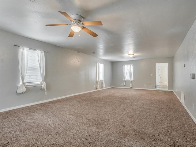 unfurnished room with carpet and ceiling fan