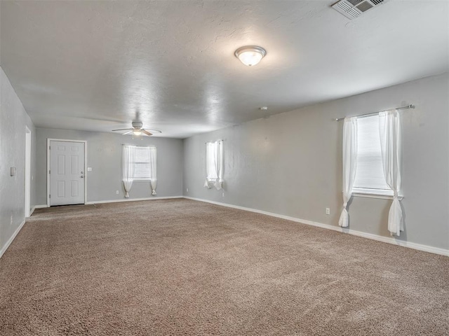 spare room featuring carpet flooring and ceiling fan