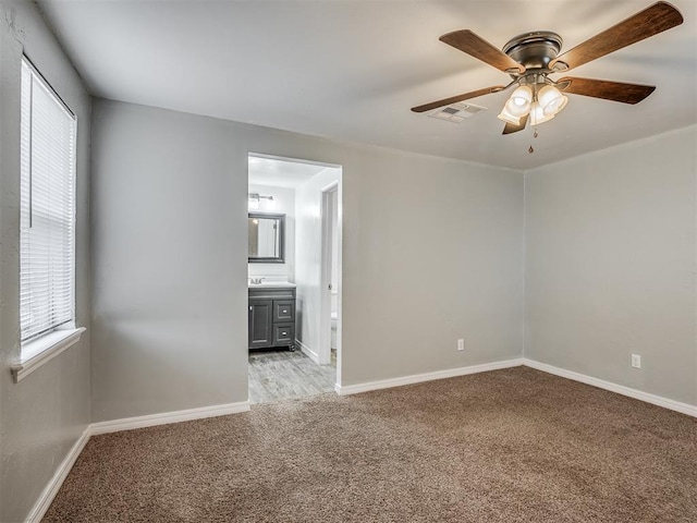 unfurnished room with light carpet and ceiling fan