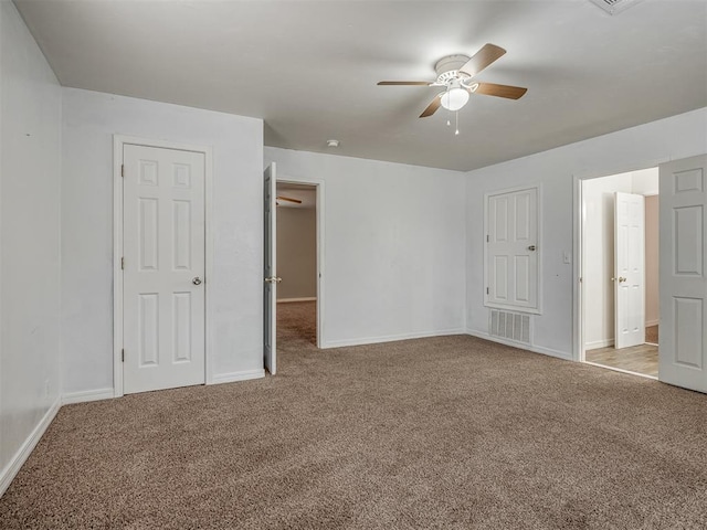 empty room featuring light carpet and ceiling fan