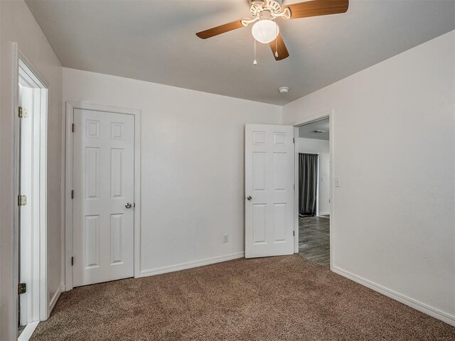 unfurnished bedroom featuring carpet flooring and ceiling fan