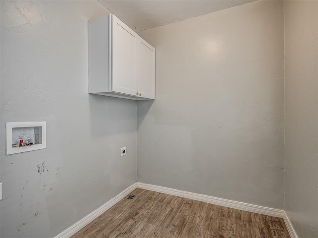 clothes washing area with electric dryer hookup, hookup for a washing machine, cabinets, and hardwood / wood-style flooring