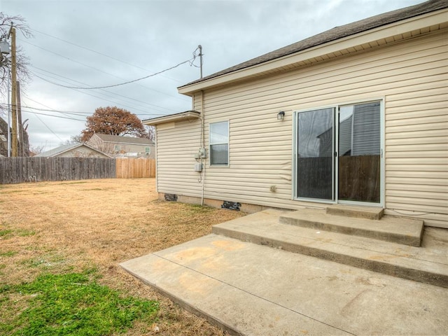 rear view of property featuring a yard and a patio