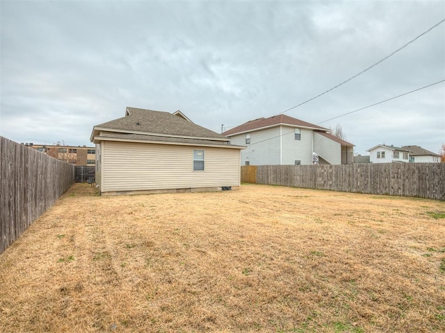 rear view of house featuring a lawn