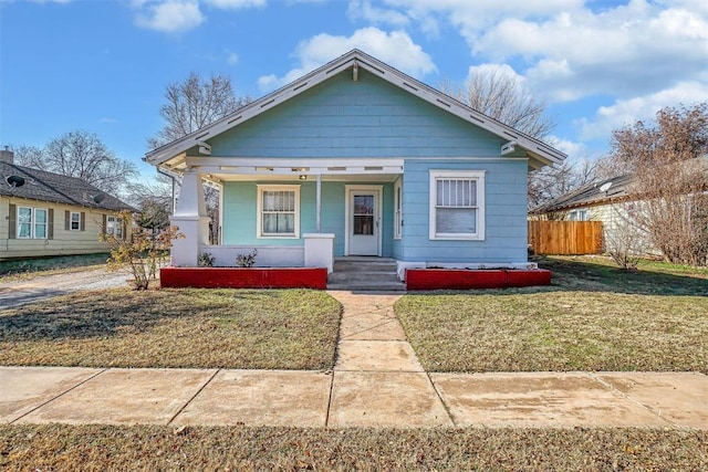 bungalow featuring a front yard and a porch