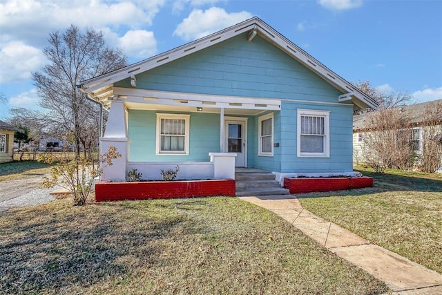 bungalow featuring a front yard and covered porch