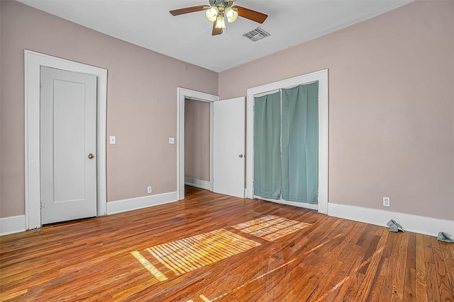 unfurnished bedroom with ceiling fan and wood-type flooring