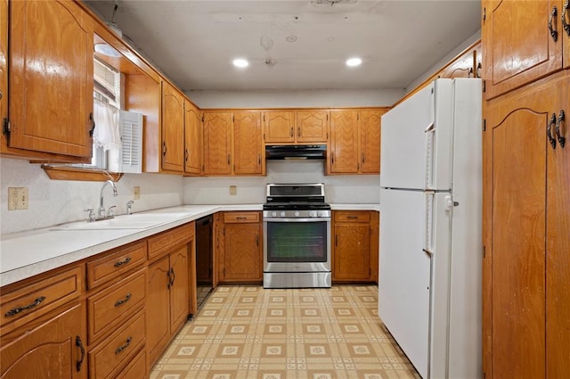 kitchen with white refrigerator, sink, black dishwasher, and stainless steel range