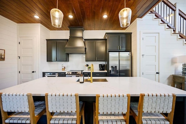 kitchen with custom exhaust hood, sink, appliances with stainless steel finishes, decorative light fixtures, and wood ceiling