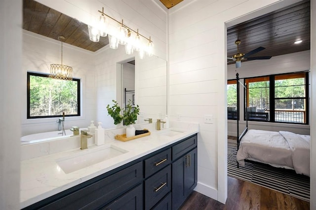 bathroom featuring a healthy amount of sunlight, ceiling fan, wood ceiling, and wood-type flooring