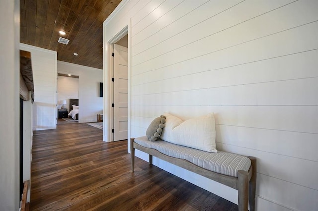 hall featuring dark wood-type flooring and wood ceiling