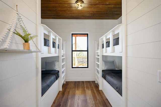 bedroom featuring dark hardwood / wood-style floors, wooden ceiling, and wooden walls