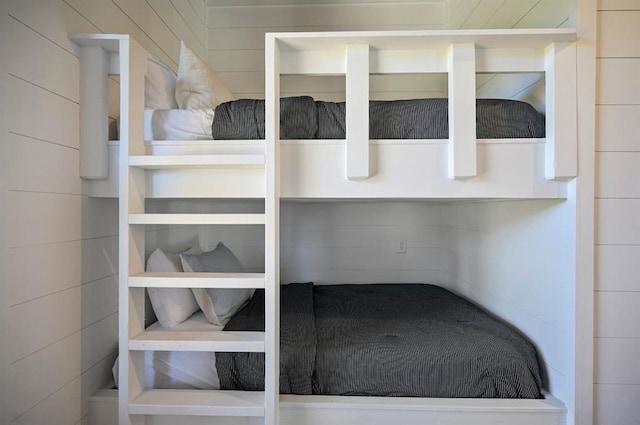 unfurnished bedroom featuring wood walls