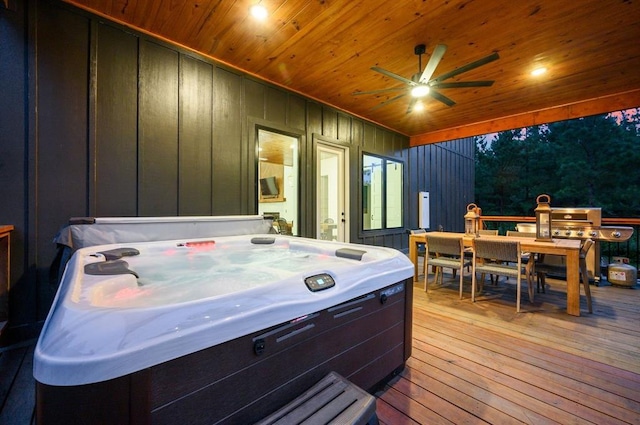 wooden terrace featuring a hot tub and ceiling fan