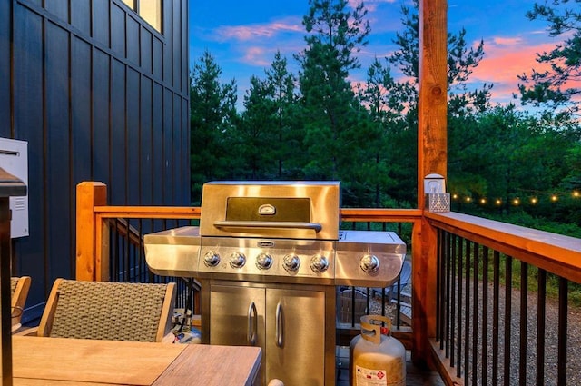 deck at dusk with grilling area