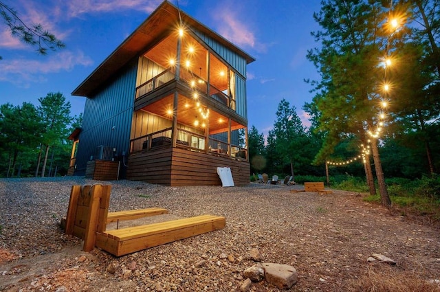 property exterior at dusk with a balcony