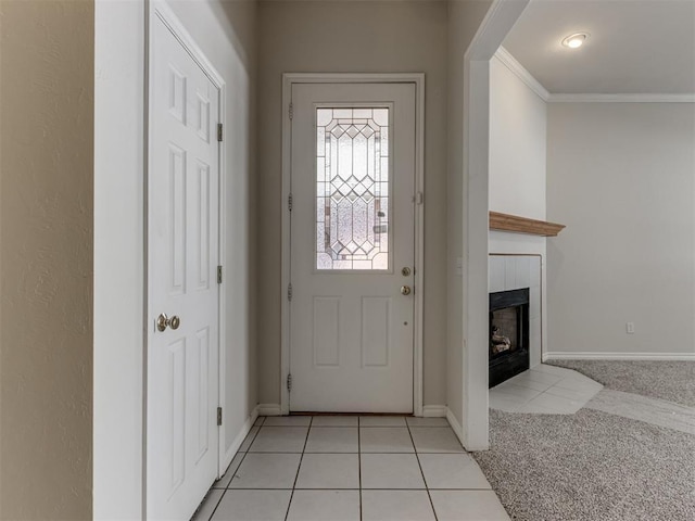 tiled entrance foyer featuring a tiled fireplace and crown molding