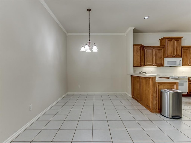 kitchen featuring light tile patterned floors, white appliances, crown molding, and a notable chandelier