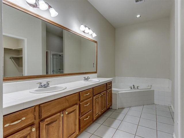 bathroom with plus walk in shower, vanity, and tile patterned floors