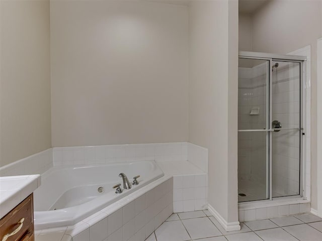 bathroom with tile patterned flooring, vanity, and independent shower and bath