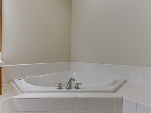 bathroom with vanity and a relaxing tiled tub