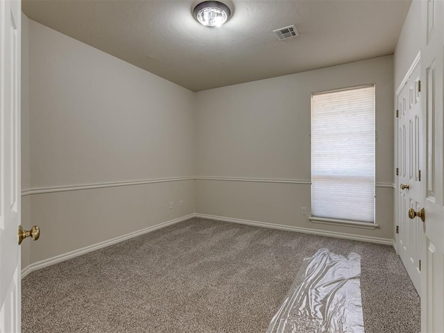 spare room featuring carpet floors