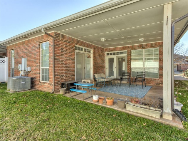 rear view of property with an outdoor hangout area, a patio, central AC unit, and a lawn