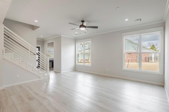 unfurnished living room featuring ceiling fan, light wood-type flooring, plenty of natural light, and ornamental molding