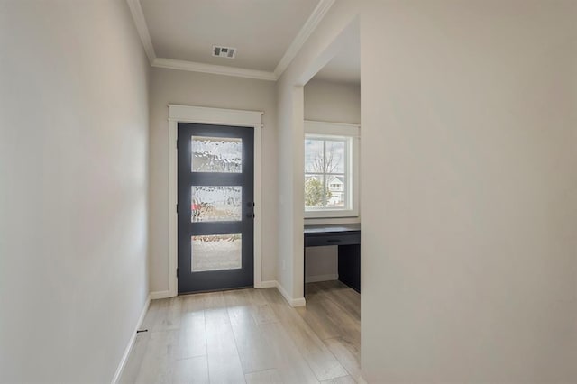 entrance foyer featuring ornamental molding and light hardwood / wood-style flooring