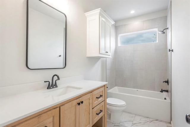 full bathroom with toilet, vanity, and tiled shower / bath