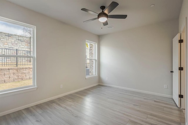 unfurnished room with ceiling fan and light hardwood / wood-style flooring