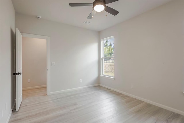 empty room featuring ceiling fan and light wood-type flooring