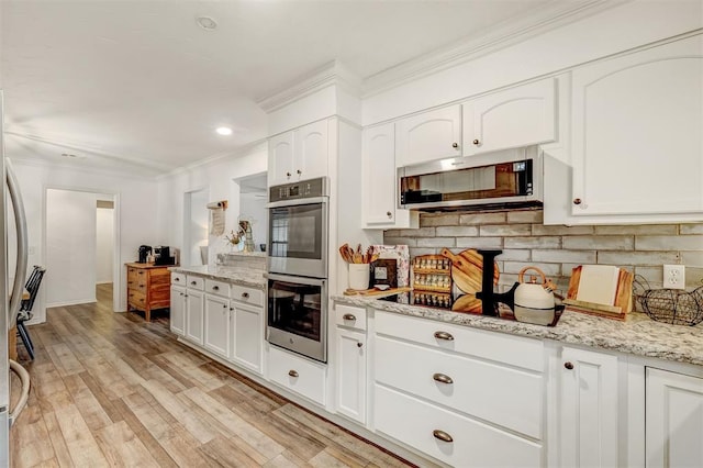 kitchen featuring white cabinets, light hardwood / wood-style flooring, light stone countertops, tasteful backsplash, and stainless steel appliances