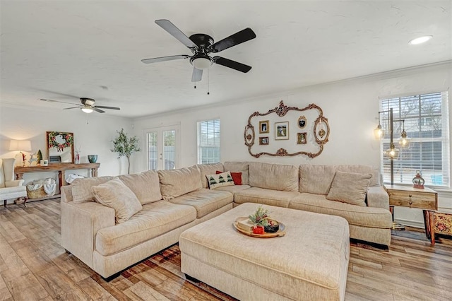 living room with french doors, light hardwood / wood-style flooring, ceiling fan, and crown molding